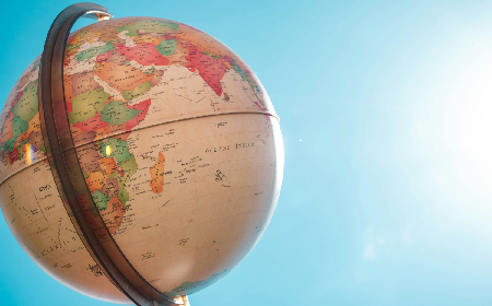 Globe in front of a blue background